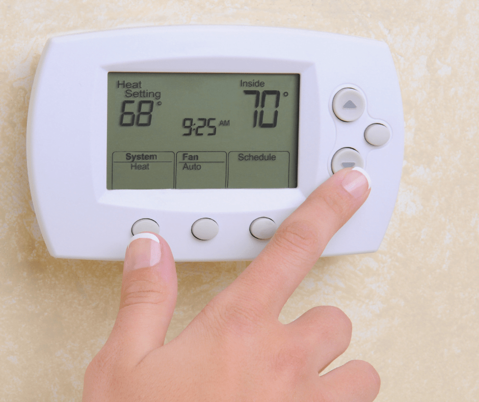 person checking thermostat