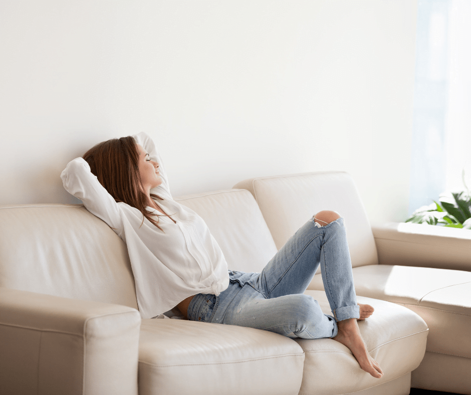 women relaxing on the couch in air conditioning