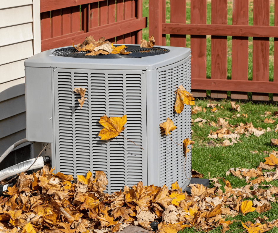 HVAC unit covered in leaves