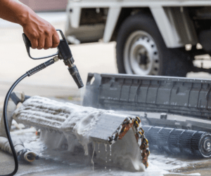 Person cleaning air conditioning unit