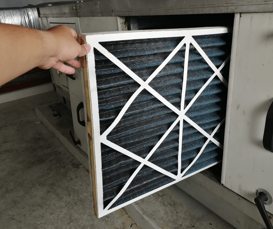 air filter being changed as a part of heating and cooling maintenance