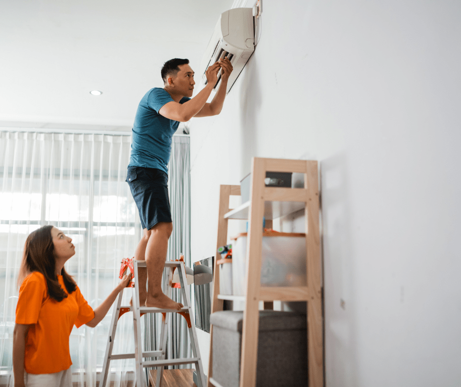 A couple performing AC maintenance at home