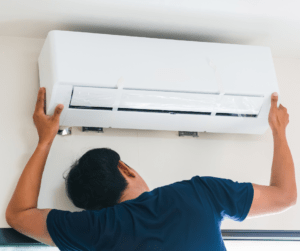 Person Fixing Heating and Air Conditioning Unit