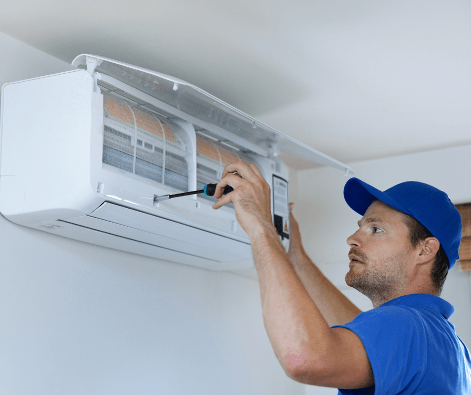 person tightening screw on HVAC system