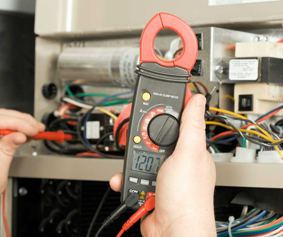 person checking HVAC systems power with a multimeter