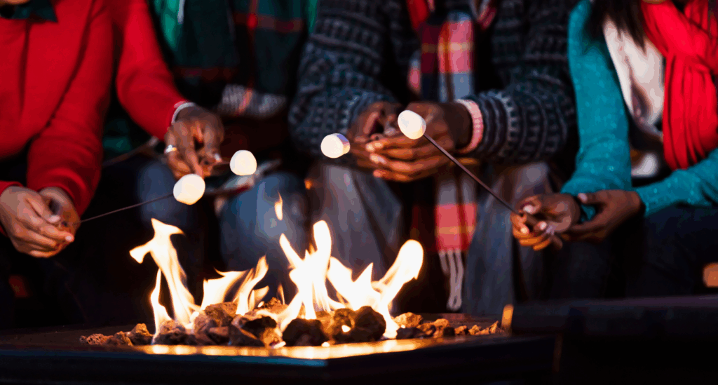 Family Cooking on a Multi-Functional Fire pit while it keeps them warm.