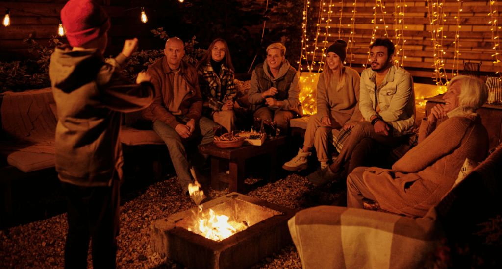 Friend Outside Relaxing and Having Fun around a Multi-Functional Fire pit.